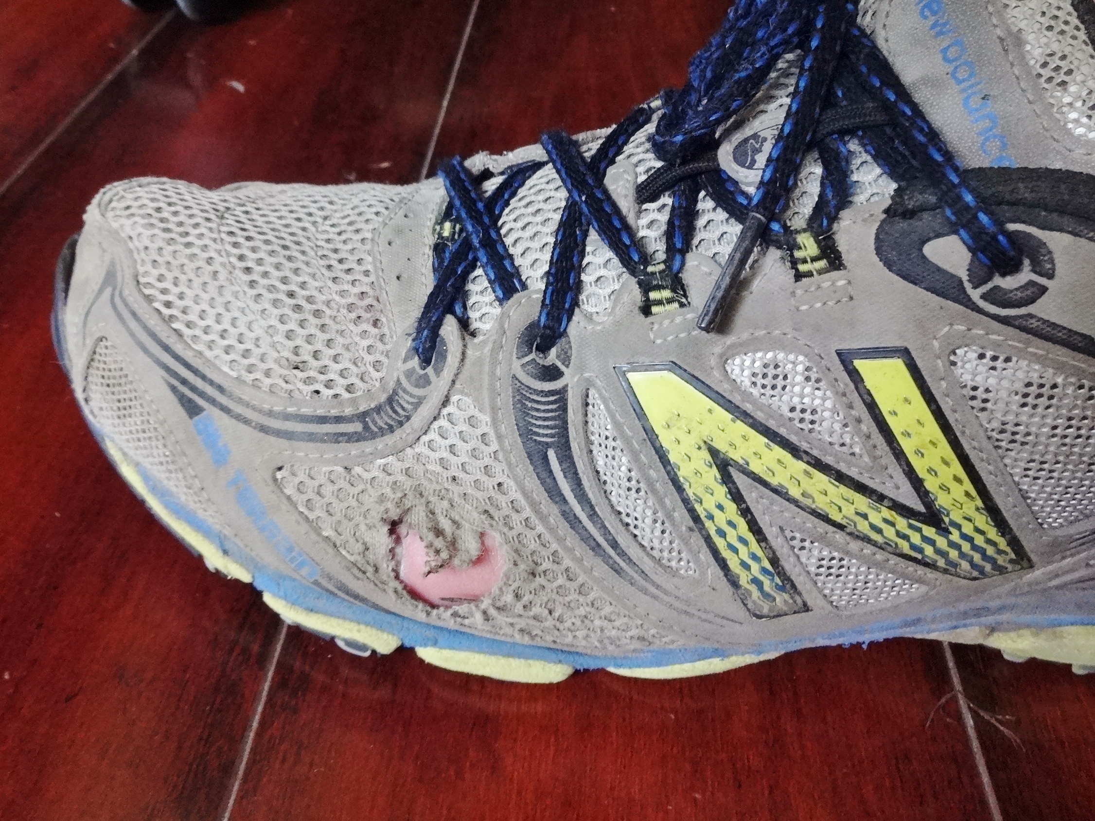 toes poking through running shoes